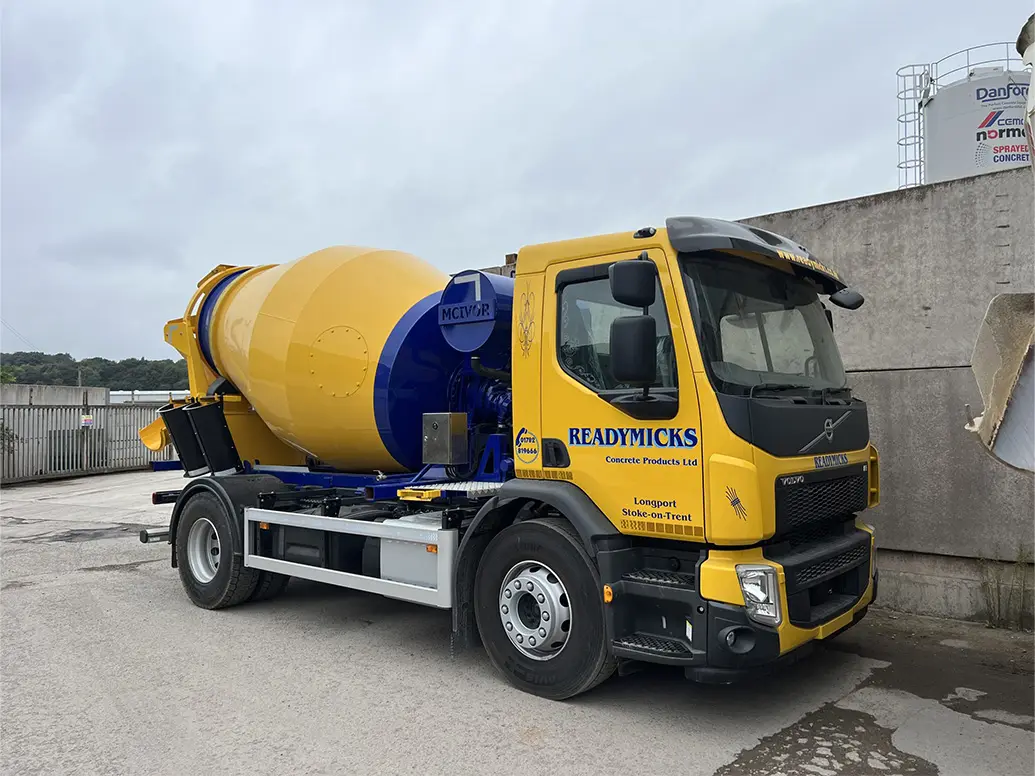 Heavy-duty mixer truck with rotating drum in action